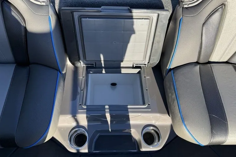 Slide: The Image of 2026 Skeeter FXR20 Apex boat interior with open storage compartment between seats. - 21
