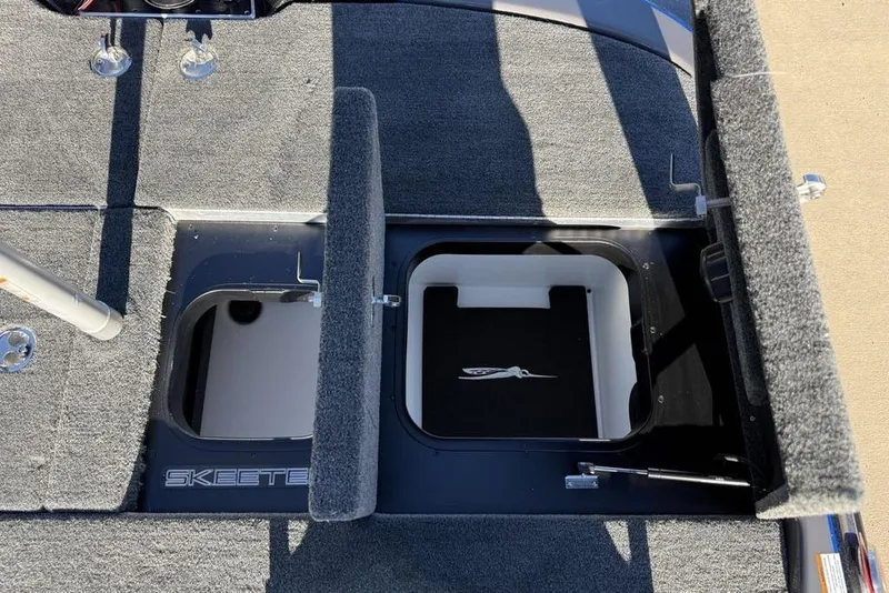 Slide: The Image of 2026 Skeeter FXR20 Apex boat storage compartments with carpeted interior and open hatches. - 23