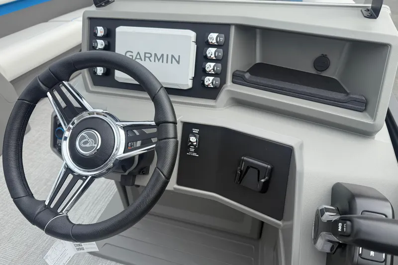 Slide: The Image of 2026 Qwest E-CLASS 22 RLS boat dashboard with Garmin navigation system and steering wheel. - 18