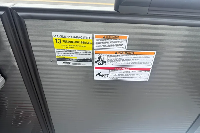 Slide: The Image of Safety warning labels on 2026 Qwest E-CLASS 22 RLS boat, detailing capacity and hazards. - 20