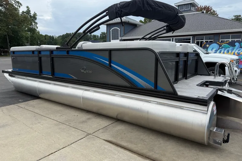 Slide: The Image of 2026 Qwest E-CLASS 22 RLS pontoon boat with sleek design and blue accents. - 5