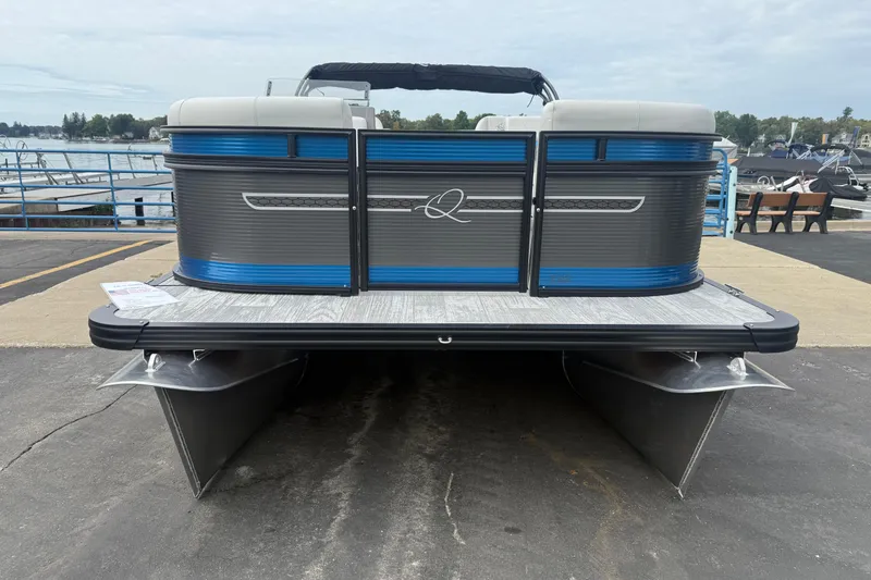 Slide: The Image of 2026 Qwest E-CLASS 22 RLS pontoon boat docked by the waterfront. - 6