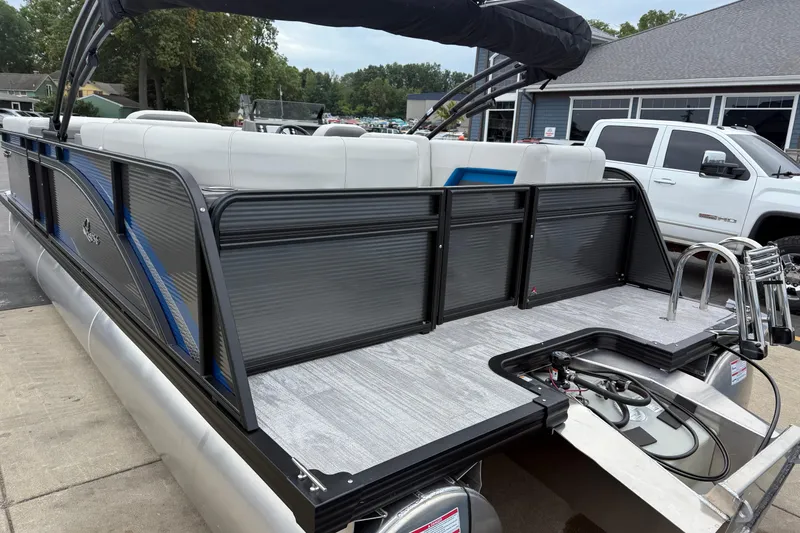Slide: The Image of 2026 Qwest E-CLASS 22 RLS pontoon boat with sleek design and modern features. - 7