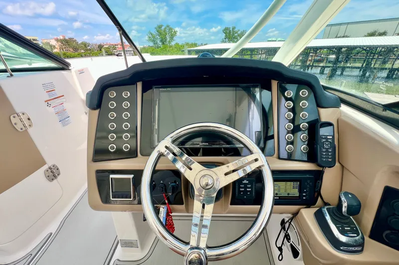 Slide: The Image of 2019 Robalo R317 Dual Console boat dashboard with steering wheel and control panel. - 10