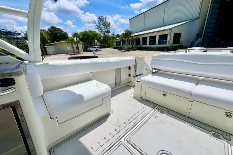Slide: The Image of 2019 Robalo R317 Dual Console boat interior with white seating and spacious deck. - 5