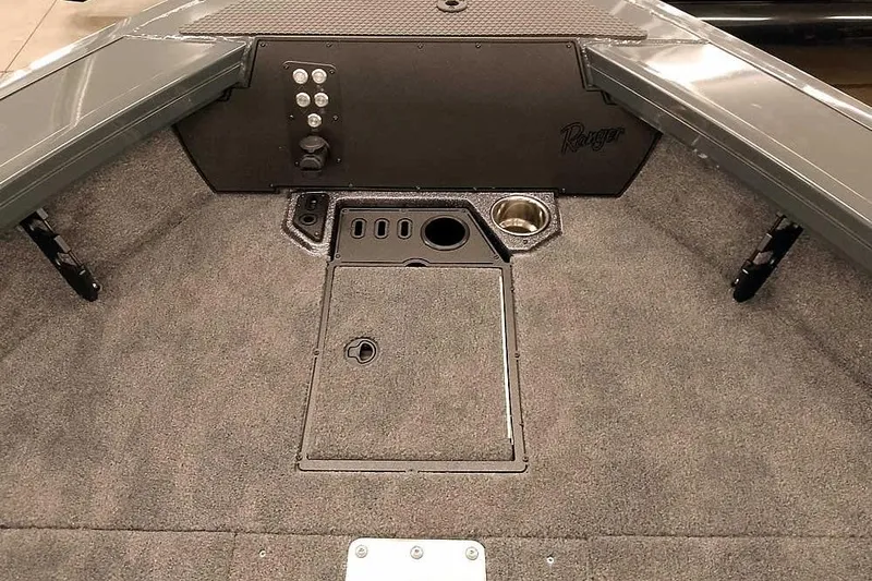 Slide: The Image of Interior of 2026 Ranger VX1988 WT boat with carpeted deck and storage compartments. - 17