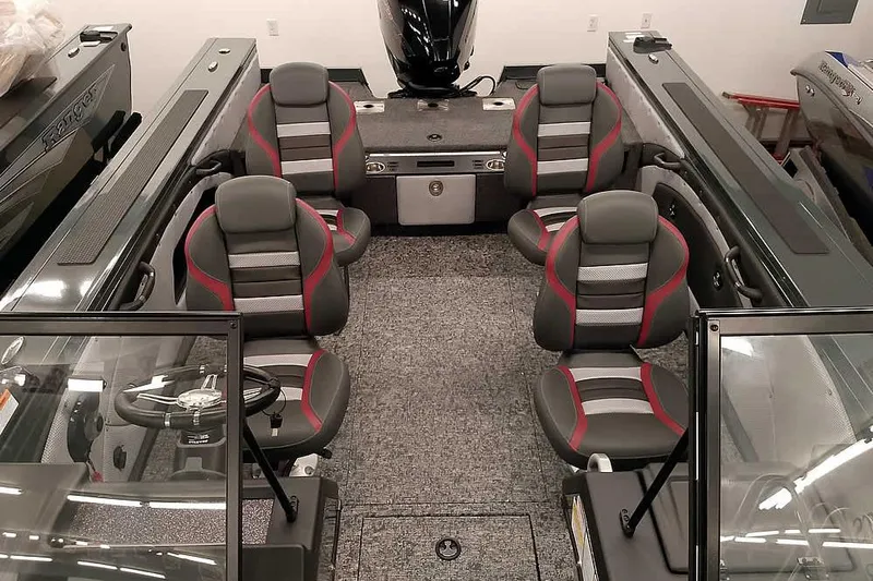 Slide: The Image of 2026 Ranger VX1988 WT boat interior with four gray and red seats, steering wheel, and carpeted floor. - 20