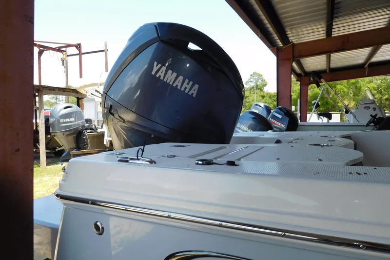 The Image of 2025 Robalo 206 Cayman boat with Yamaha outboard engines in a covered storage area. - 1