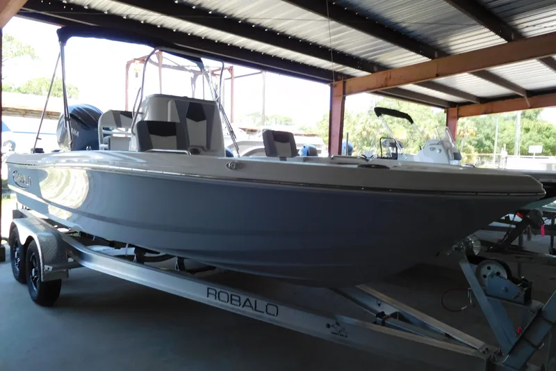 Slide: The Image of 2025 Robalo 206 Cayman boat on trailer in covered storage area. - 4