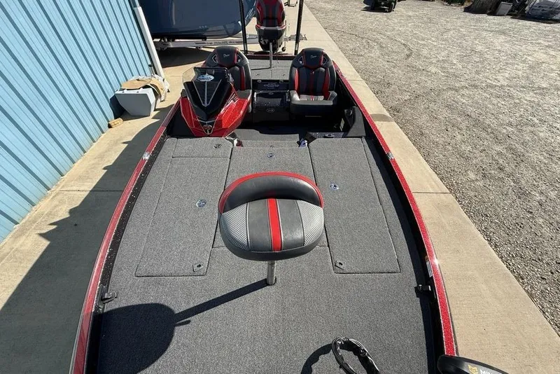 Slide: The Image of 2023 Ranger Z520R Ranger Cup Equipped boat with red and gray seating, docked outdoors. - 26