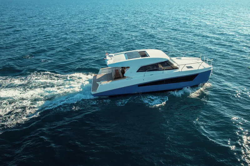 Slide: The Image of 2025 Makai M37 yacht cruising on open blue sea. - 101