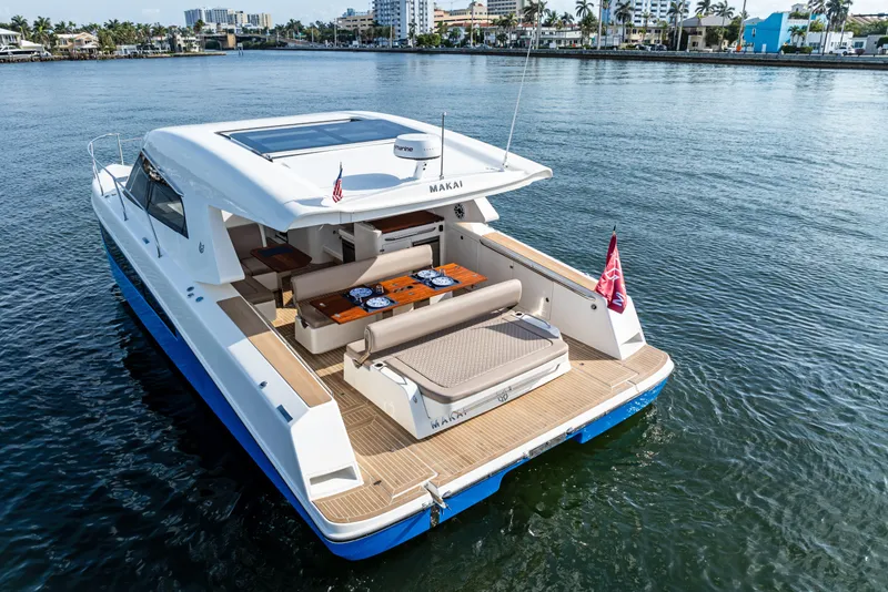 Slide: The Image of 2025 Makai M37 yacht on water, featuring spacious deck and modern design. - 2