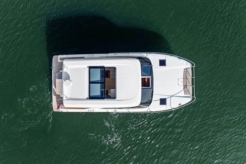 Slide: The Image of Overhead view of 2025 Makai M37 yacht on calm green water. - 25