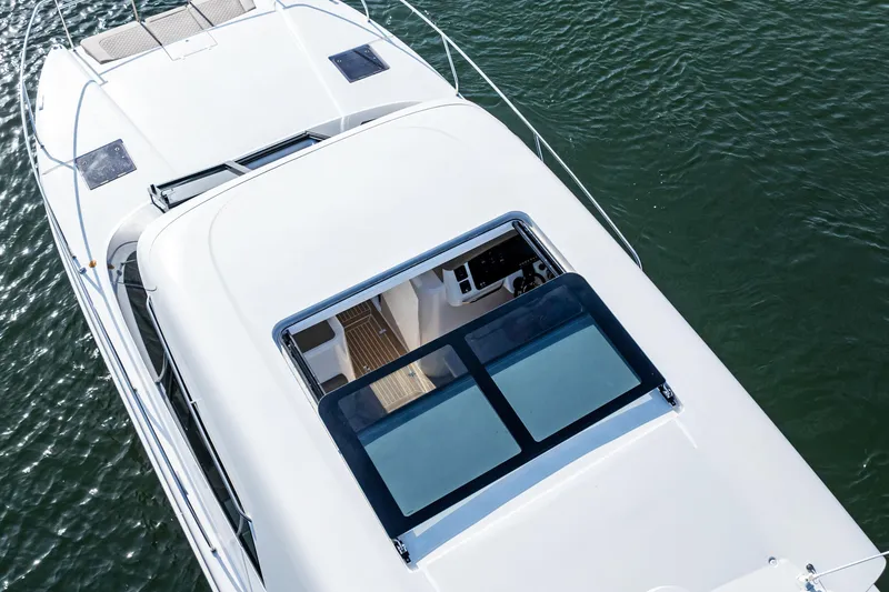 Slide: The Image of Aerial view of 2025 Makai M37 yacht on water, showcasing sleek design and spacious deck. - 27