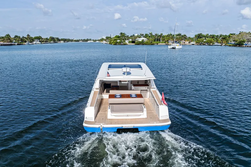 Slide: The Image of 2025 Makai M37 yacht cruising on a scenic waterway, surrounded by lush greenery. - 30