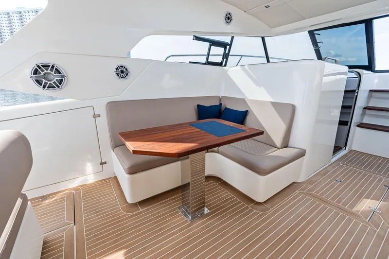 Slide: The Image of Luxurious interior of 2025 Makai M37 yacht with elegant seating and wooden table. - 37