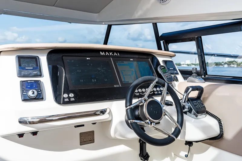 Slide: The Image of Helm of 2025 Makai M37 boat with advanced navigation controls and steering wheel. - 40