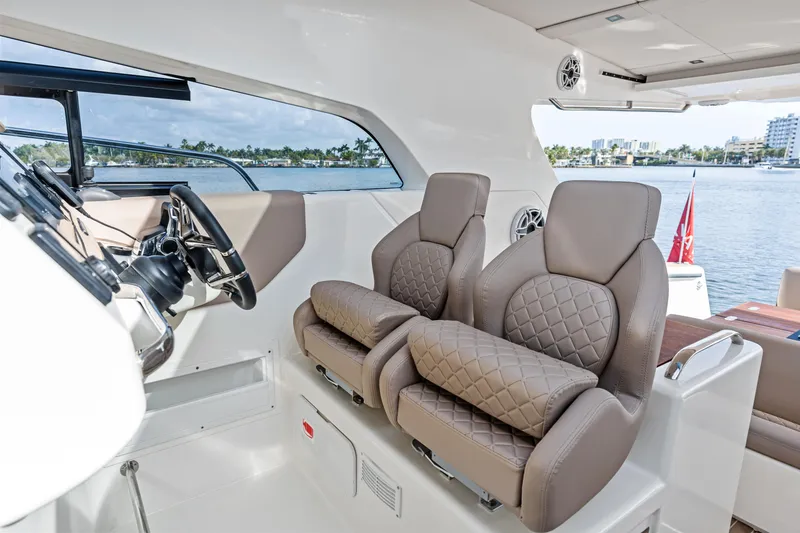 Slide: The Image of Luxurious interior of 2025 Makai M37 yacht with plush seating and modern steering. - 41
