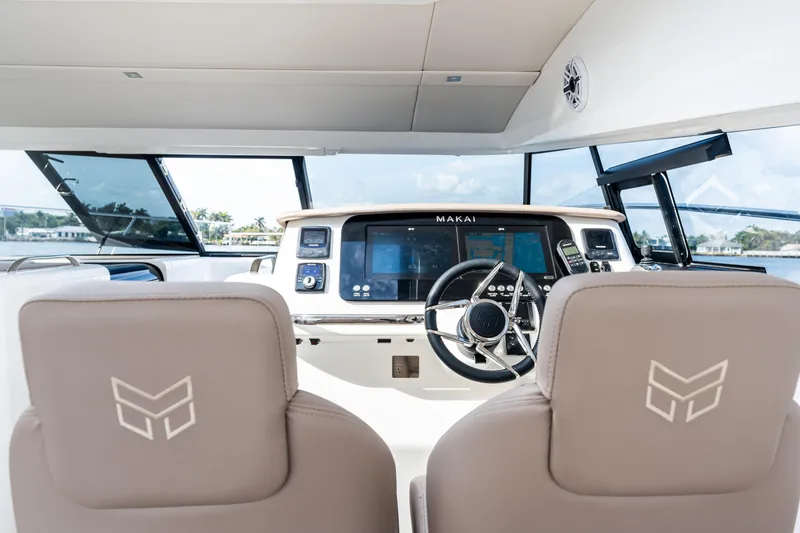 Slide: The Image of Interior view of 2025 Makai M37 yacht cockpit with modern steering and navigation system. - 43