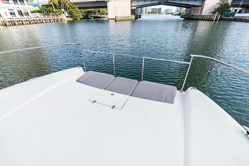 Slide: The Image of Front deck of 2025 Makai M37 yacht on a calm waterway under a bridge. - 59
