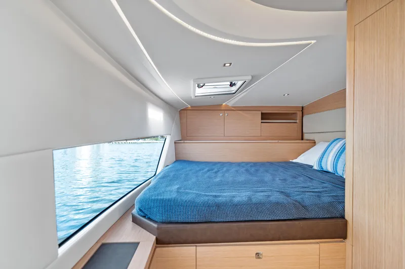 Slide: The Image of Luxurious cabin interior of 2025 Makai M37 yacht with large window and cozy bed. - 62