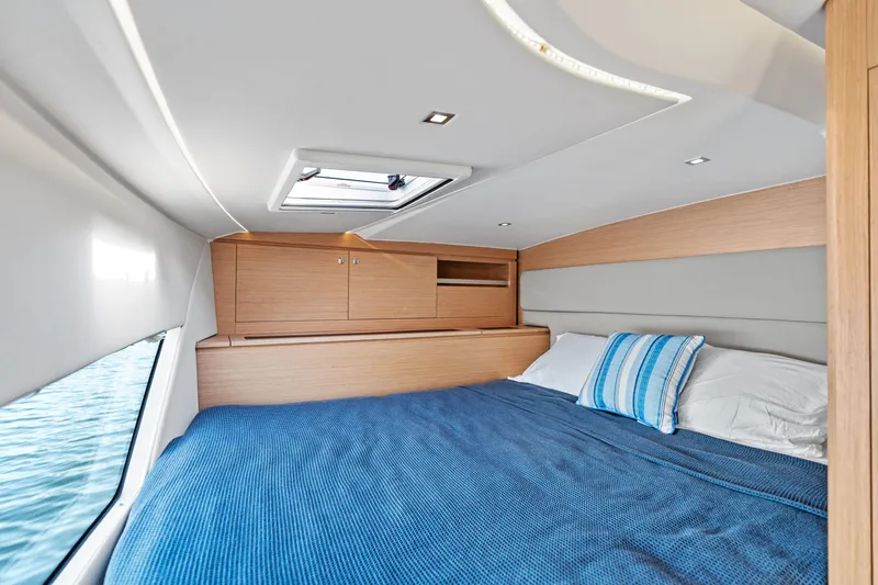Slide: The Image of Luxurious cabin interior of 2025 Makai M37 yacht with cozy bedding and wooden cabinetry. - 64