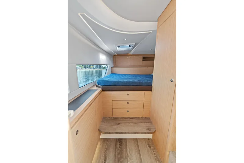 Slide: The Image of Luxurious interior of 2025 Makai M37 yacht with cozy bed and wooden cabinetry. - 65