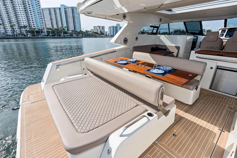 Slide: The Image of Luxurious 2025 Makai M37 yacht interior with elegant seating and dining area, docked by waterfront buildings. - 73