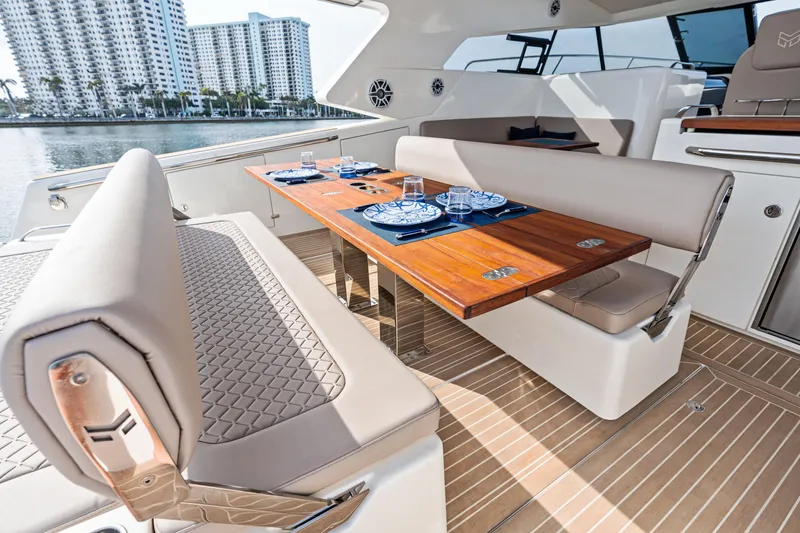 Slide: The Image of Luxurious 2025 Makai M37 yacht interior with elegant dining area and waterfront view. - 74