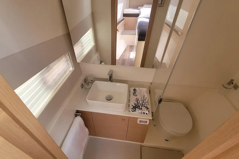 Slide: The Image of Modern bathroom in 2025 Makai M37 yacht with sleek sink, toilet, and mirror. - 79