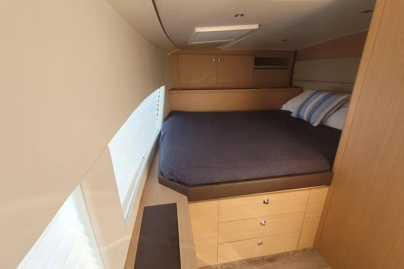 Slide: The Image of Luxurious cabin interior of 2025 Makai M37 with cozy bed and wooden storage. - 80