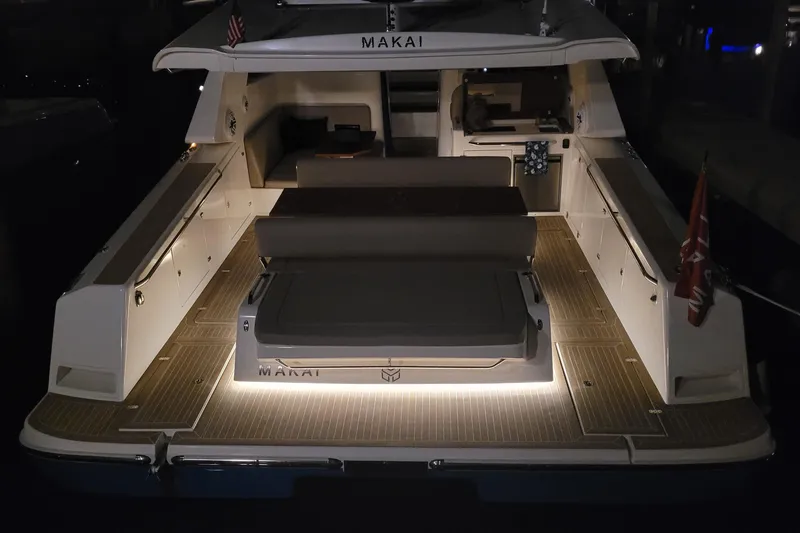 Slide: The Image of 2025 Makai M37 yacht with illuminated deck at night, showcasing luxury and elegance. - 89