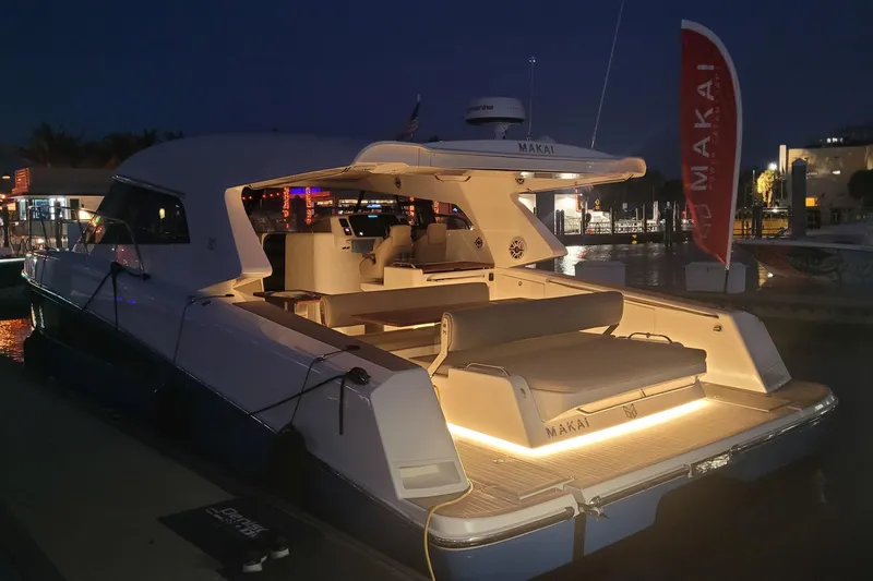 Slide: The Image of Luxurious 2025 Makai M37 yacht illuminated at night in a marina setting. - 90