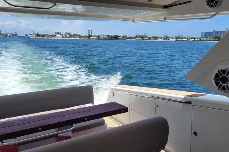 Slide: The Image of Luxury Makai M37 yacht cruising on blue waters, 2025 model, with scenic coastal view. - 91