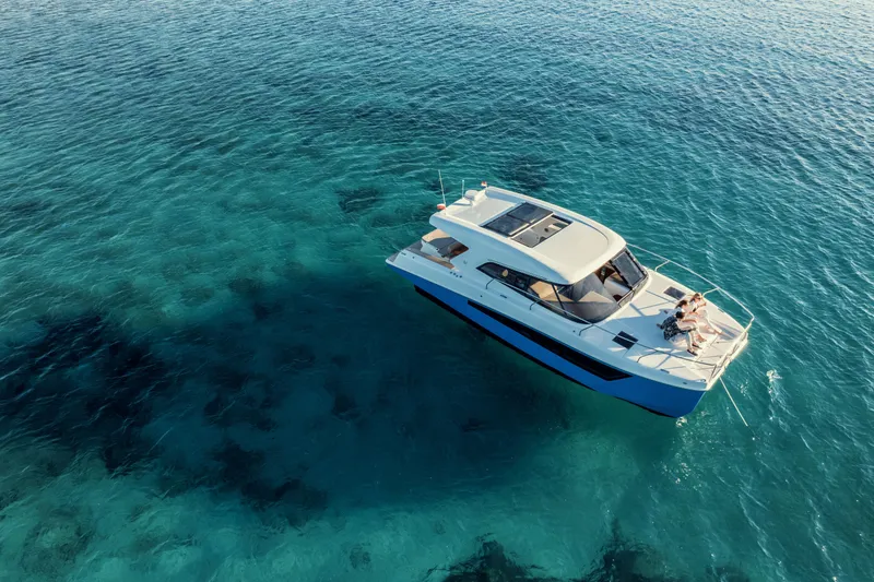 Slide: The Image of 2025 Makai M37 yacht cruising on clear blue ocean waters. - 99