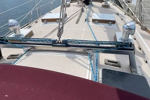 Slide: The Image of 1985 Shannon 43 Ketch sailboat deck with rigging and cleats, docked at marina. - 11