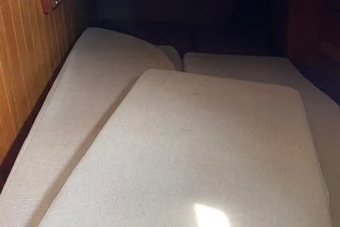 Slide: The Image of Interior cabin view of 1985 Shannon 43 Ketch sailboat with beige cushions. - 6