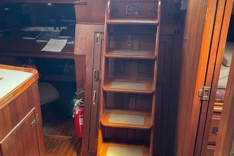 Slide: The Image of Interior of 1985 Shannon 43 Ketch sailboat with wooden ladder and cozy cabin space. - 9