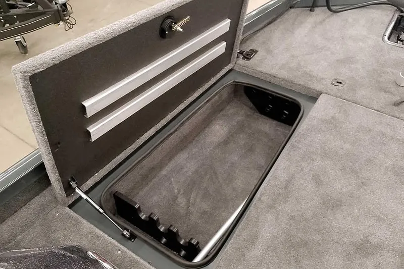 Slide: The Image of 2026 Ranger RT198P Fishing Package storage compartment with open lid, showcasing interior space. - 16
