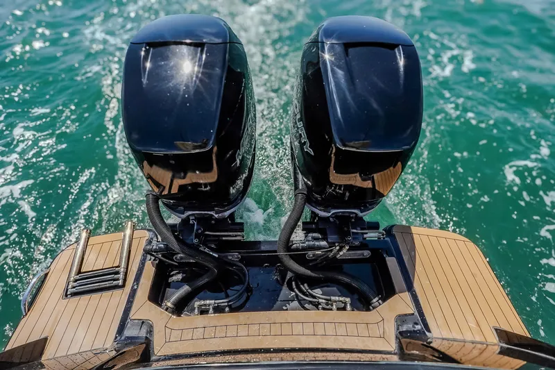Slide: The Image of 2017 Scout 300 LXF boat with dual outboard motors on turquoise water. - 11