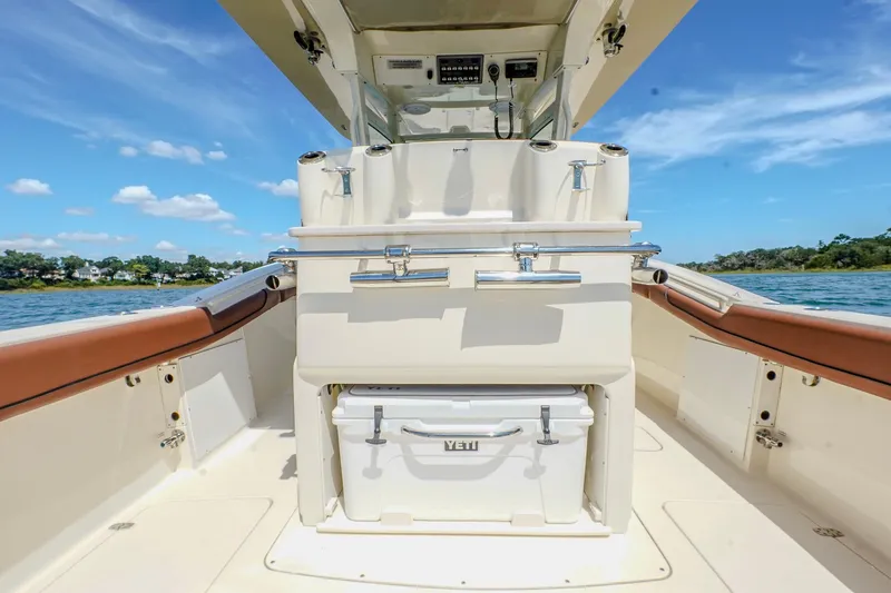 Slide: The Image of 2017 Scout 300 LXF boat interior with Yeti cooler, ocean view, and clear blue sky. - 15