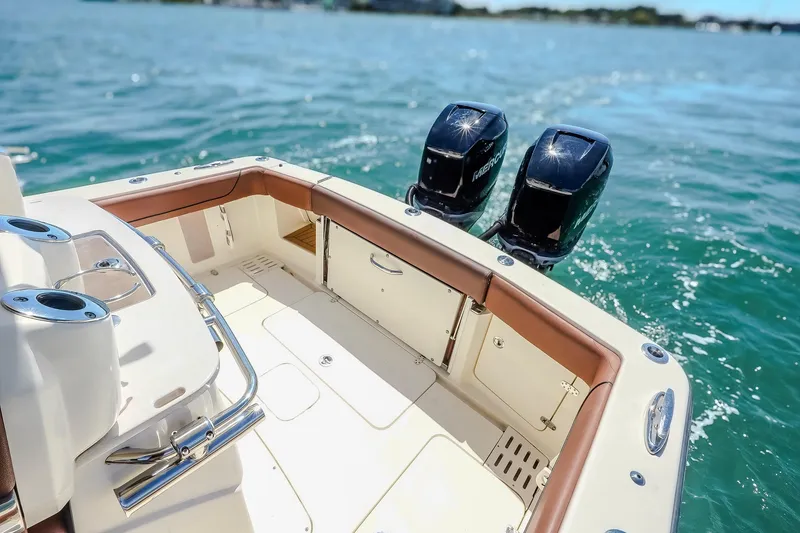 Slide: The Image of 2017 Scout 300 LXF boat with dual engines on open water. - 17