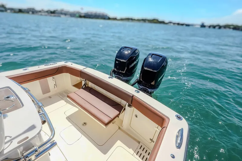 Slide: The Image of 2017 Scout 300 LXF boat with dual Mercury engines on open water. - 18