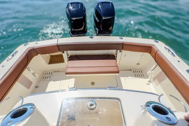 Slide: The Image of 2017 Scout 300 LXF boat deck with twin engines on water. - 19
