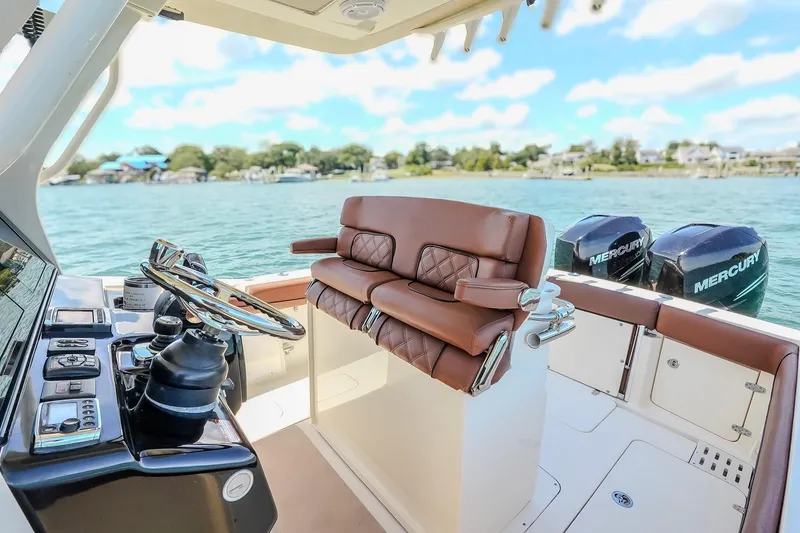 Slide: The Image of 2017 Scout 300 LXF boat interior with leather seating and dual Mercury engines. - 21