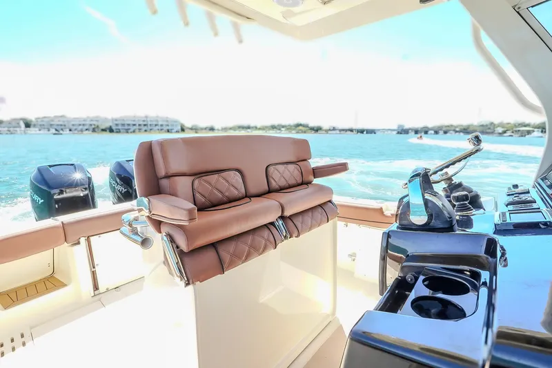 Slide: The Image of Luxurious interior of 2017 Scout 300 LXF boat with leather seating and dual Mercury engines. - 22