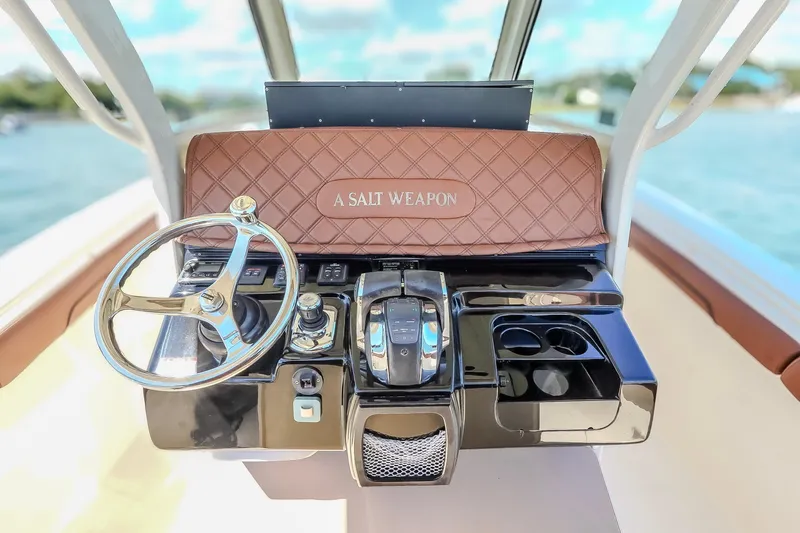 Slide: The Image of 2017 Scout 300 LXF boat dashboard with steering wheel and controls, labeled "A Salt Weapon." - 25