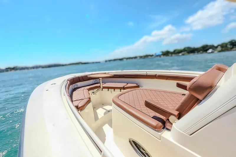 Slide: The Image of 2017 Scout 300 LXF boat interior with luxurious seating on a sunny day. - 28