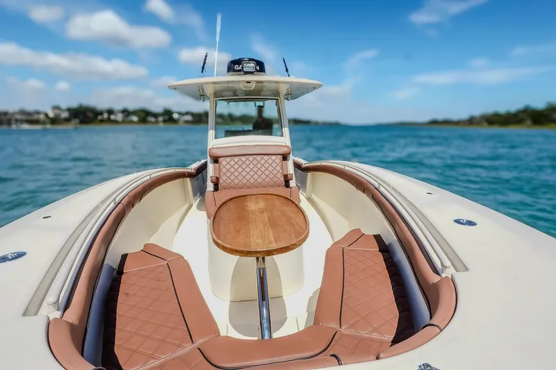 Slide: The Image of 2017 Scout 300 LXF boat with luxurious seating on a sunny day. - 29