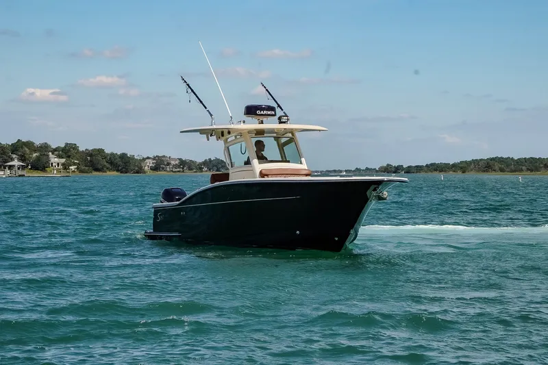 Slide: The Image of 2017 Scout 300 LXF boat cruising on a sunny day in calm waters. - 3